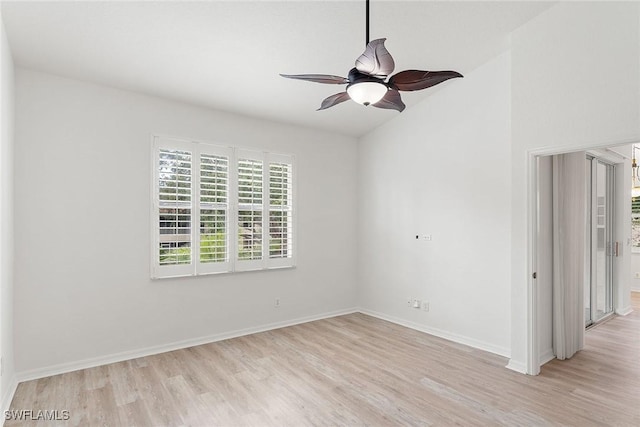 unfurnished room with light wood finished floors, baseboards, lofted ceiling, and a ceiling fan
