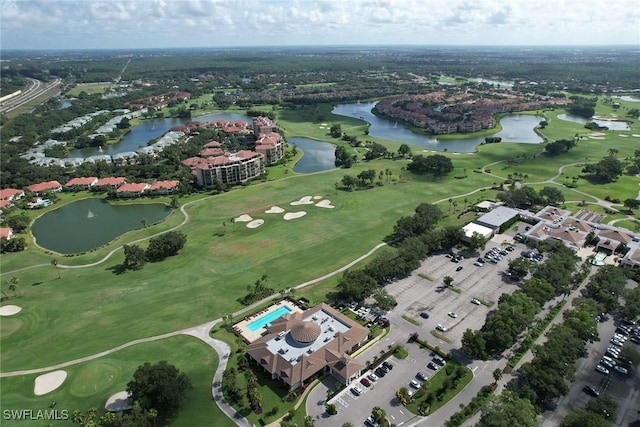 birds eye view of property with a water view and golf course view