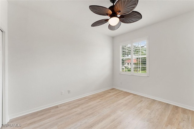 empty room with light wood-type flooring, baseboards, and a ceiling fan