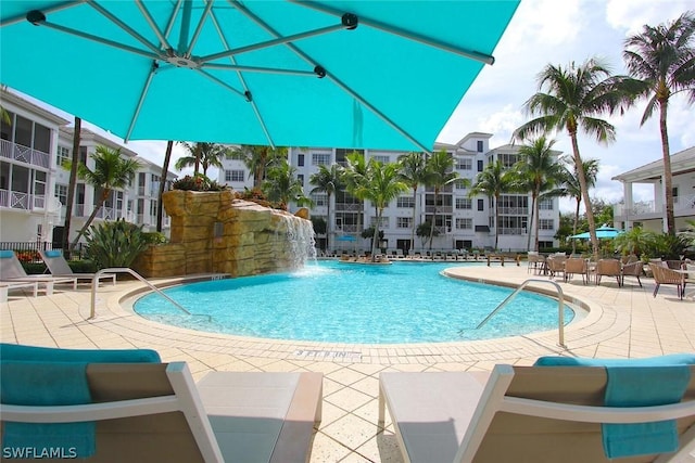 view of pool featuring pool water feature and a patio