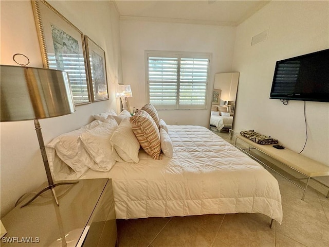 bedroom featuring tile patterned floors and crown molding