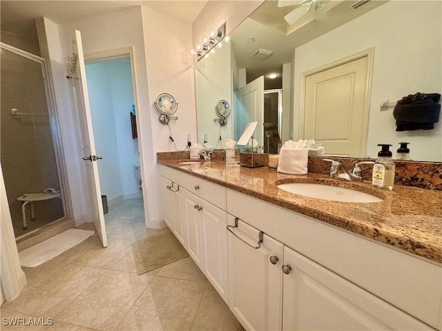 bathroom with tile patterned floors, vanity, and walk in shower