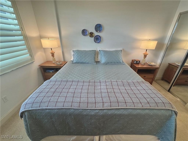 bedroom featuring light colored carpet