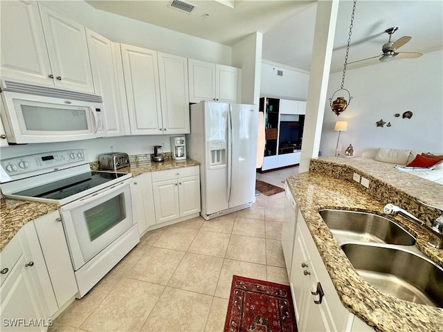 kitchen with white appliances, sink, ceiling fan, light tile patterned floors, and white cabinetry