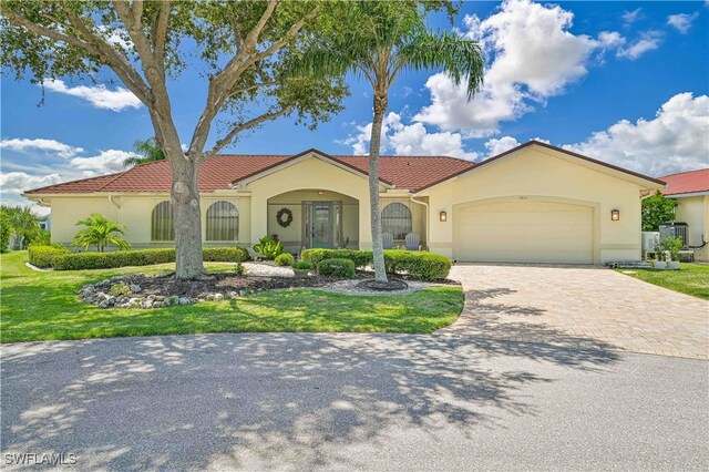 mediterranean / spanish-style house with a garage