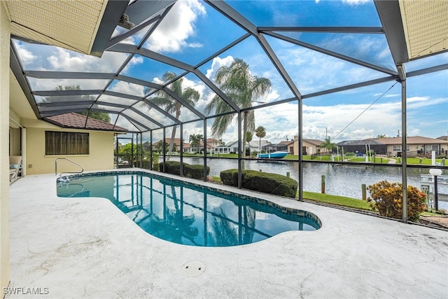 view of swimming pool with a water view, a patio, and glass enclosure