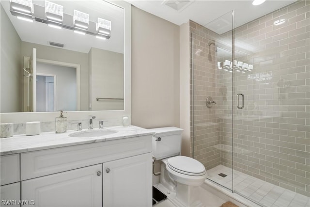 bathroom with vanity, toilet, and an enclosed shower