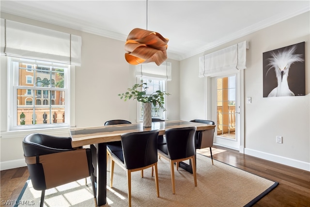 dining area with ornamental molding and hardwood / wood-style floors