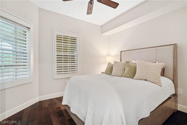 bedroom with dark hardwood / wood-style floors and ceiling fan