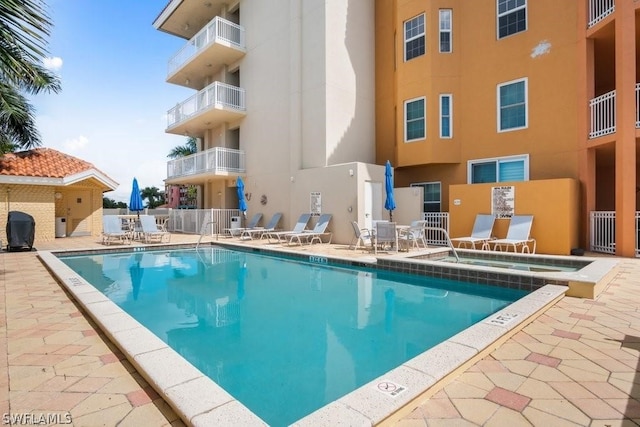 view of pool featuring a community hot tub and a patio