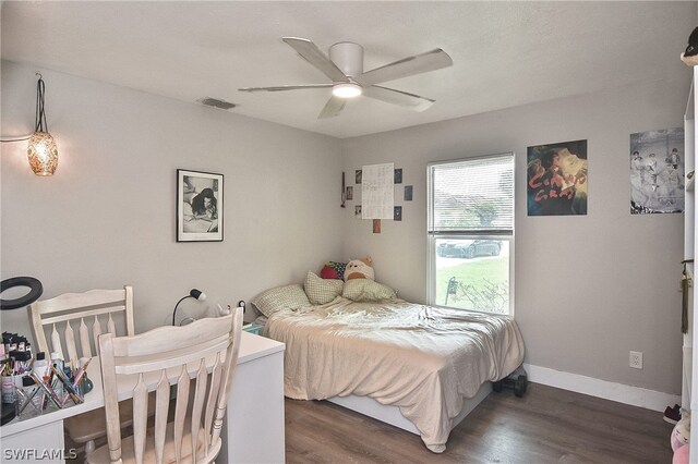 bedroom with ceiling fan and dark wood-type flooring