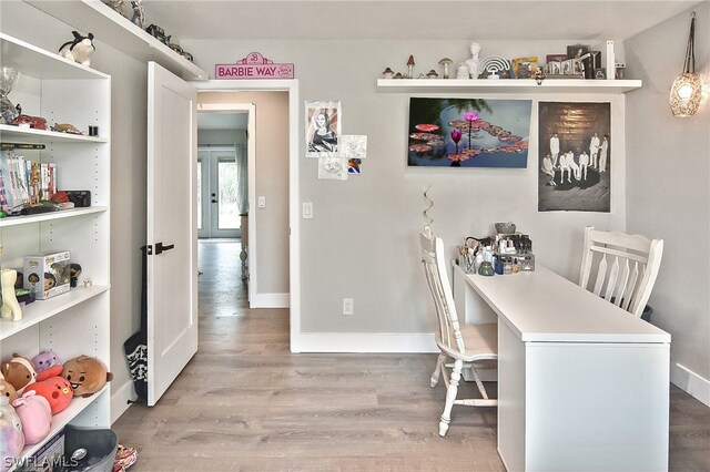 home office with hardwood / wood-style floors