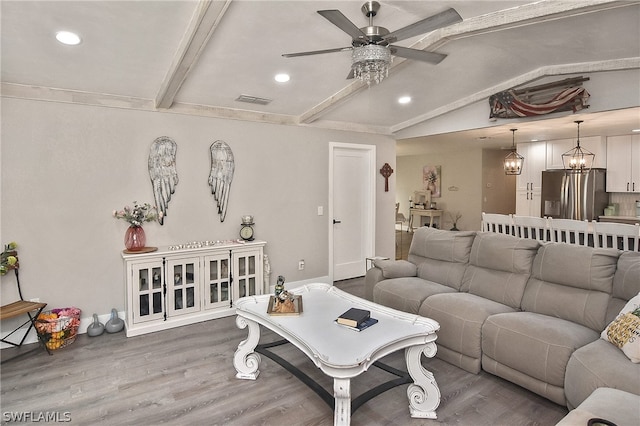 living room with vaulted ceiling with beams, ceiling fan with notable chandelier, and wood-type flooring