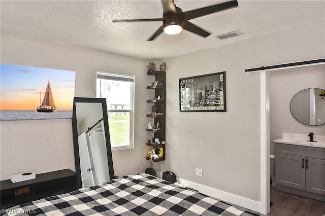 bedroom with dark wood-type flooring, sink, and ceiling fan