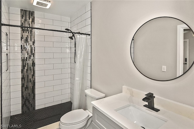 bathroom with vanity, curtained shower, and toilet