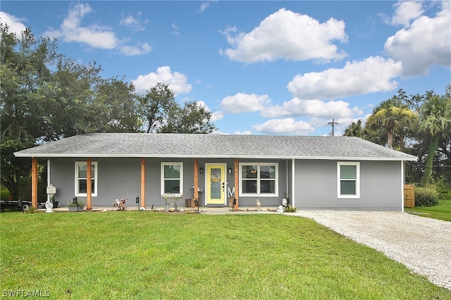 ranch-style house with a porch, driveway, a front yard, and roof with shingles