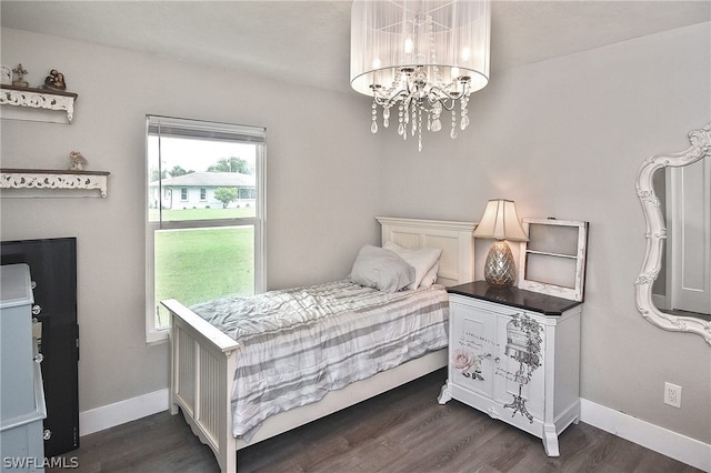 bedroom featuring a chandelier and dark hardwood / wood-style flooring