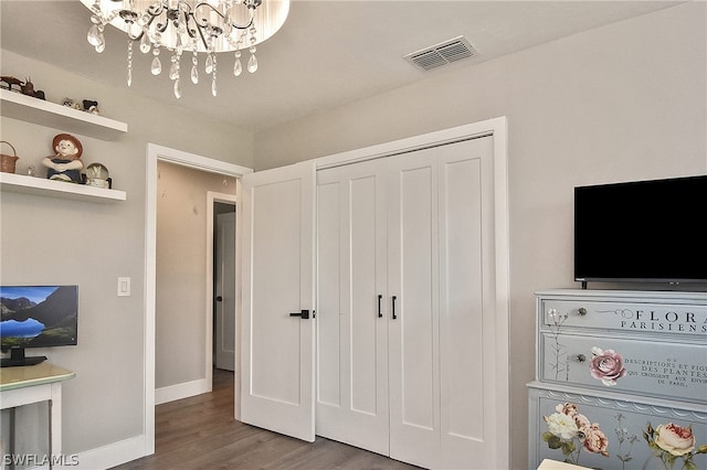 bedroom featuring a notable chandelier and hardwood / wood-style floors