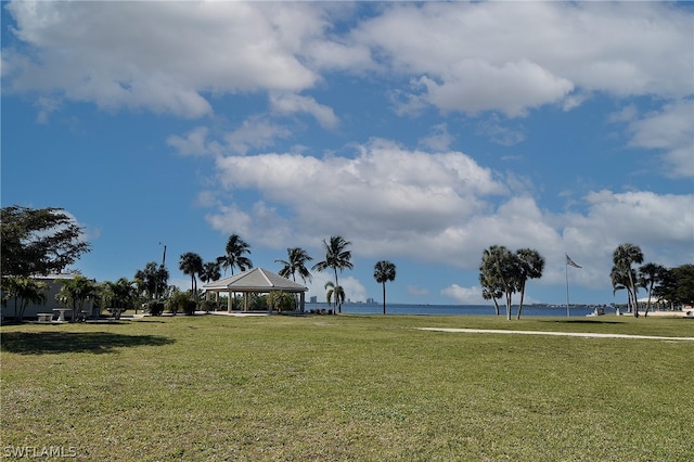 view of community featuring a water view, a lawn, and a gazebo