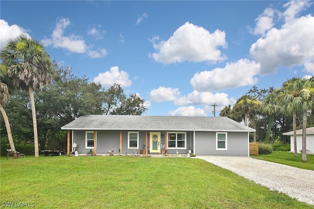 ranch-style home with covered porch and a front yard