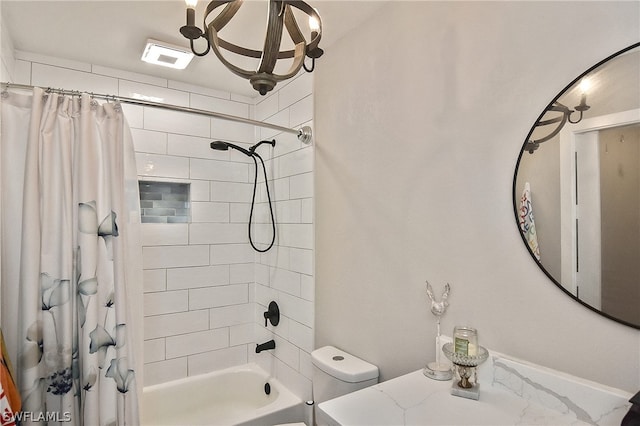 bathroom featuring shower / tub combo and toilet