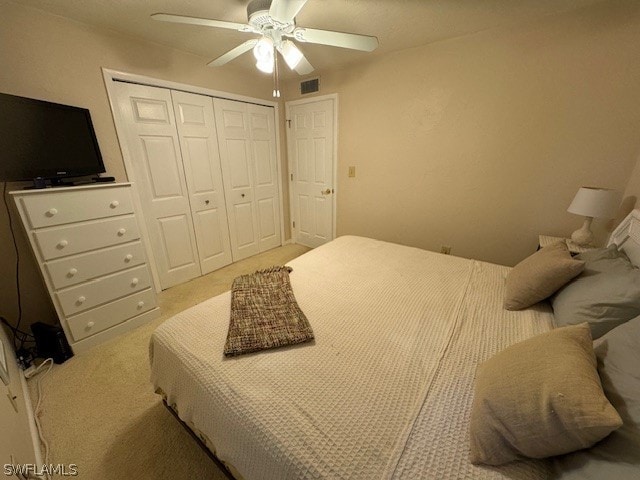 carpeted bedroom featuring ceiling fan and a closet