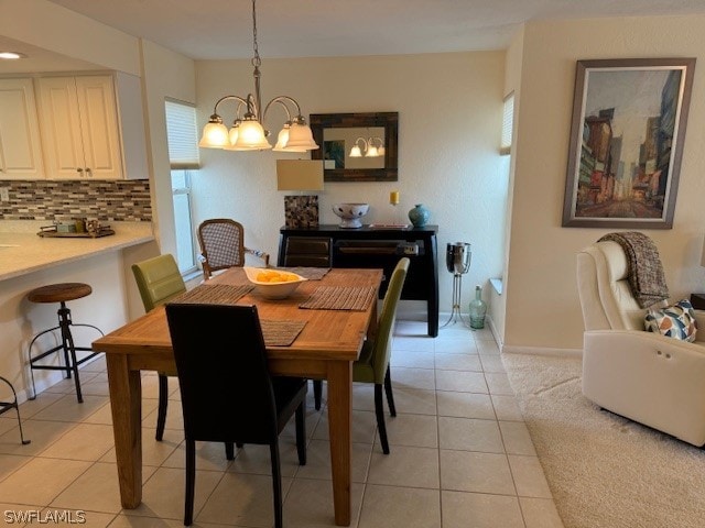 dining space featuring light tile patterned floors and a notable chandelier