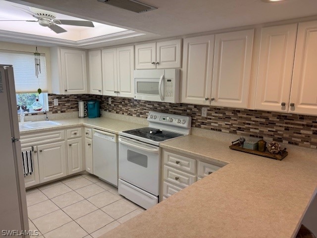 kitchen featuring white appliances, ceiling fan, sink, white cabinetry, and light tile patterned flooring