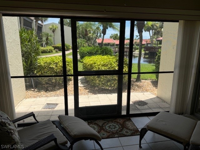 entryway featuring a water view and tile patterned floors