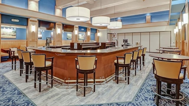 bar featuring wood walls and decorative light fixtures