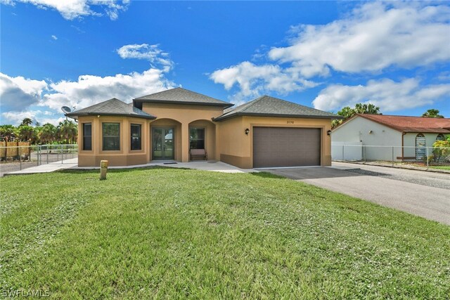 view of front of home featuring a garage and a front yard