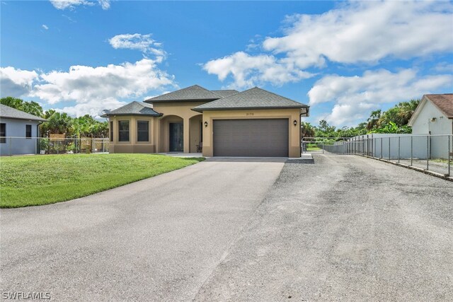 view of front of house featuring a garage and a front lawn