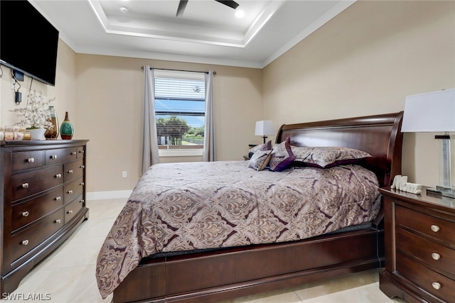 tiled bedroom with ceiling fan and a raised ceiling