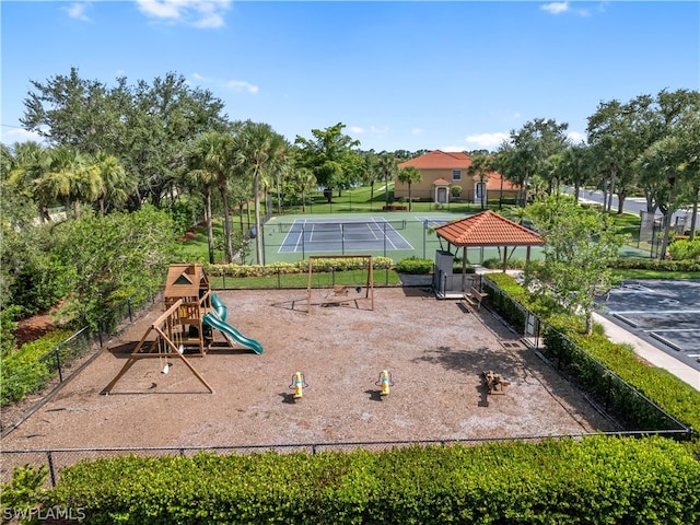 view of patio featuring tennis court and a playground