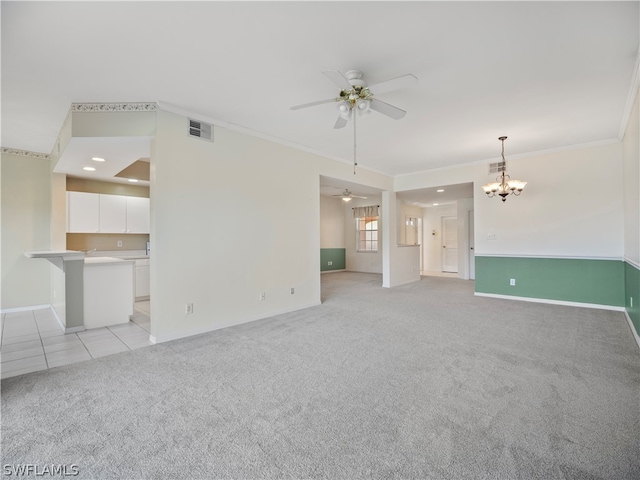 unfurnished living room with ceiling fan with notable chandelier, light colored carpet, and ornamental molding