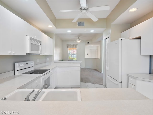 kitchen featuring white cabinetry, light carpet, ceiling fan, and white appliances