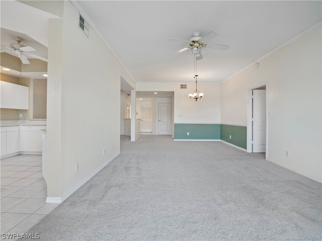 empty room featuring light carpet, ceiling fan with notable chandelier, and crown molding