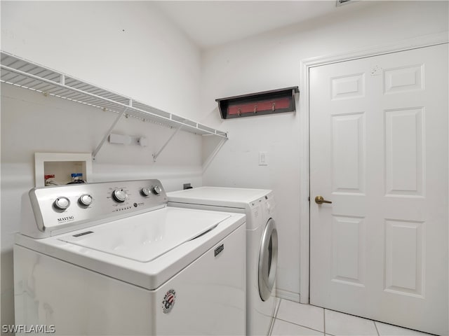 washroom featuring independent washer and dryer and light tile patterned floors