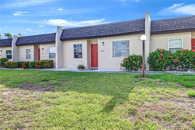 ranch-style home featuring a front yard