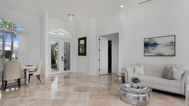 living room featuring french doors and crown molding