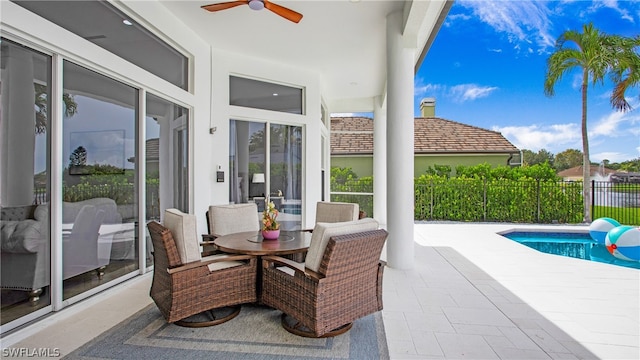 view of patio with ceiling fan and a fenced in pool