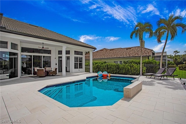 view of pool featuring ceiling fan, a patio, fence, an outdoor living space, and a fenced in pool