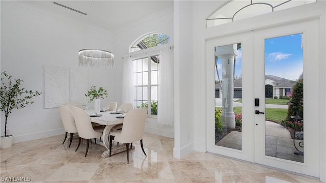 dining room with ornamental molding and french doors