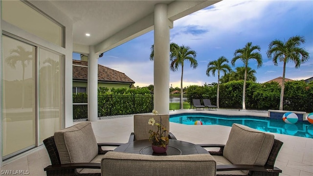 view of swimming pool with a patio area, fence, and a fenced in pool