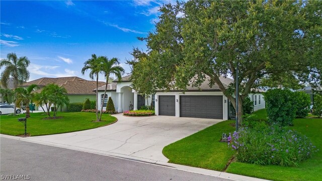 view of front of property featuring a garage and a front lawn