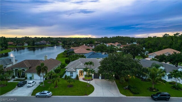 aerial view at dusk with a water view