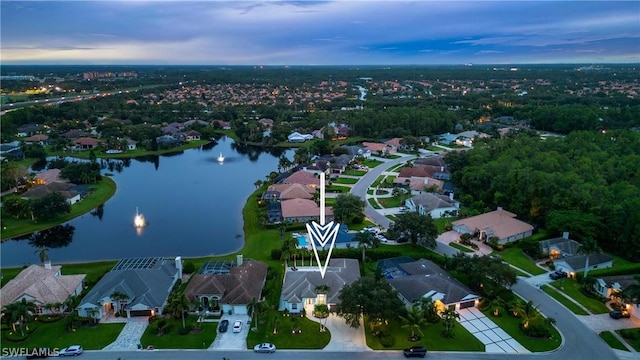 aerial view at dusk with a water view