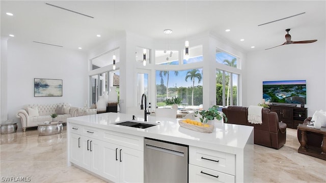 kitchen featuring light countertops, open floor plan, white cabinetry, a sink, and dishwasher