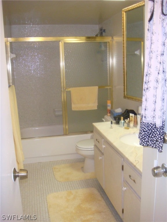 full bathroom with toilet, vanity, tile patterned flooring, and bath / shower combo with glass door