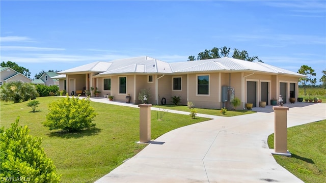 view of front of property with a garage and a front lawn